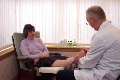 Lady receiving reflexology treatment
